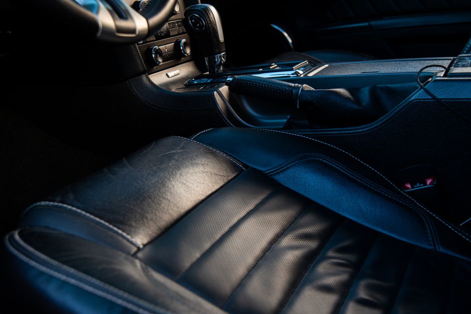 Close-up of a luxurious car interior with leather seating, showcasing style and comfort.